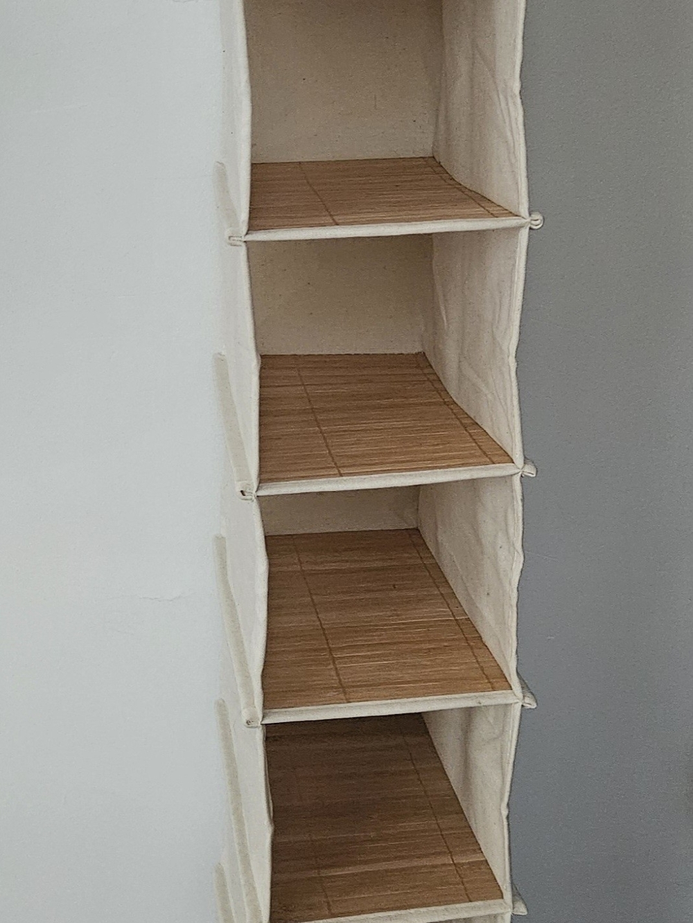 Neutral Canvas Hanging Shelf Organizer with Bamboo Shelves.